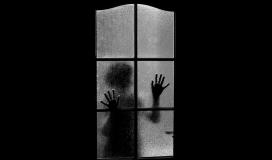 Un enfant derrière une porte-fenêtre